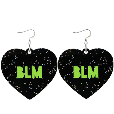 An image of Haus of Dizzy's Large ‘BLM’ heart shaped dangle earrings, with Apple Green  “BLM’ text on Black Glitter acrylic on Hooks