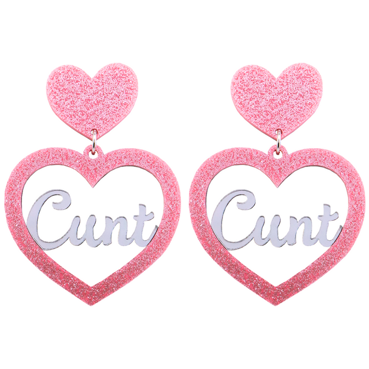An image of Haus of Dizzy's Large ‘Cunt' heart shaped dangle earrings, with mirror "Cunt" text on a Baby Pink Glitter acrylic stud heart.