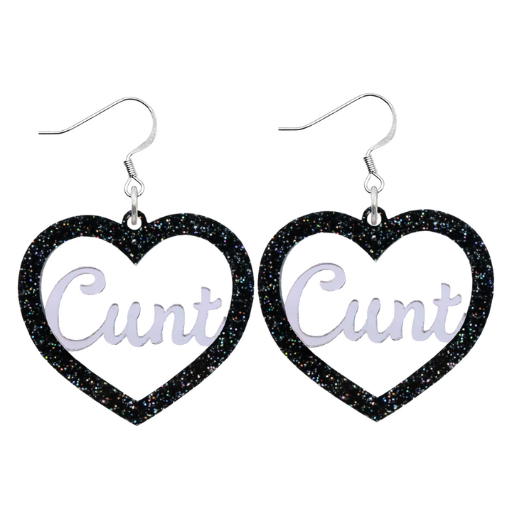 An image of Haus of Dizzy's Large ‘Cunt' heart shaped dangle earrings, with mirror "Cunt" text on a Black Glitter acrylic on hook.