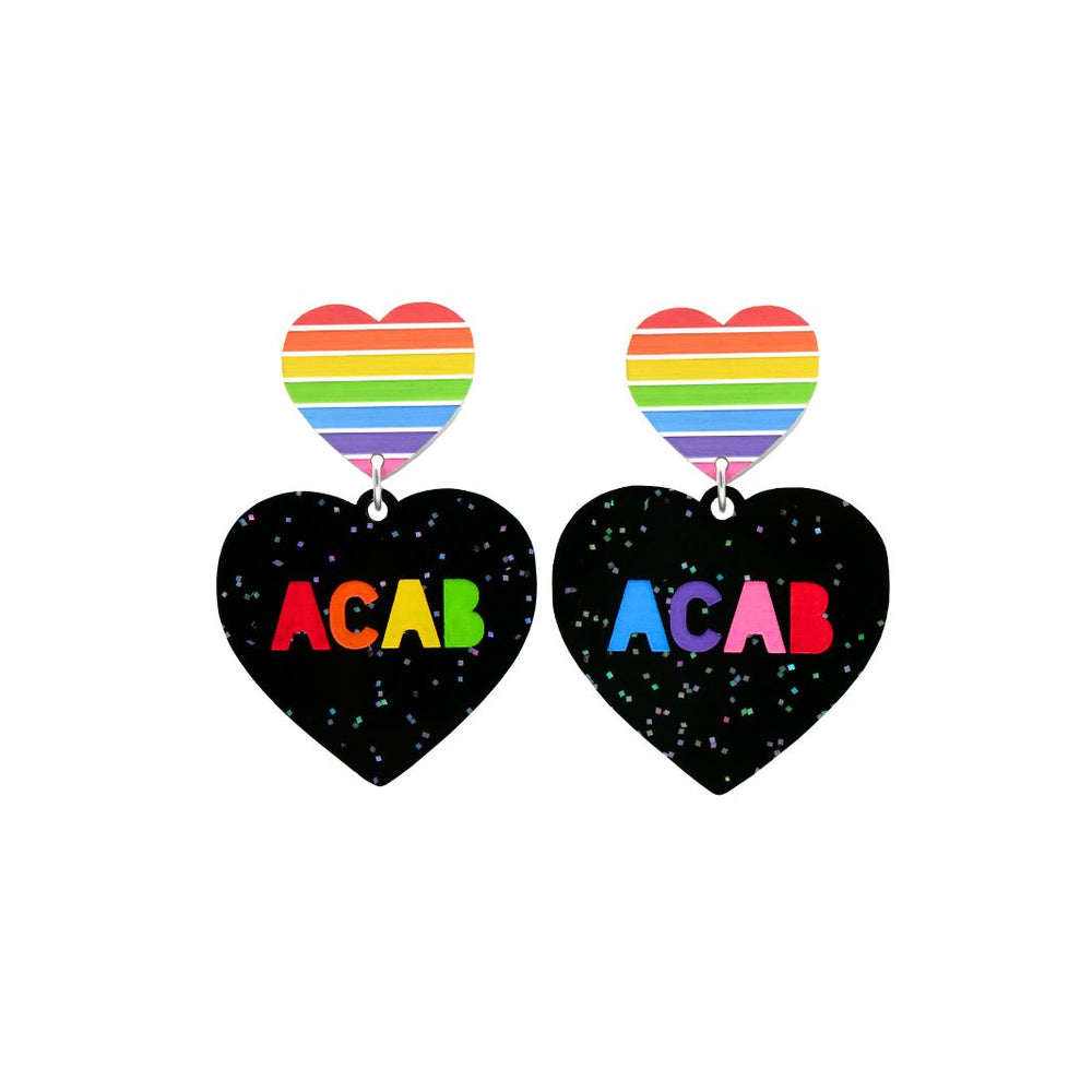 An image of Haus of Dizzy's small 'F U ACAB' heart-shaped dangle earrings, with “ACAB” rainbow text on black glitter acrylic and a pride rainbow heart top.