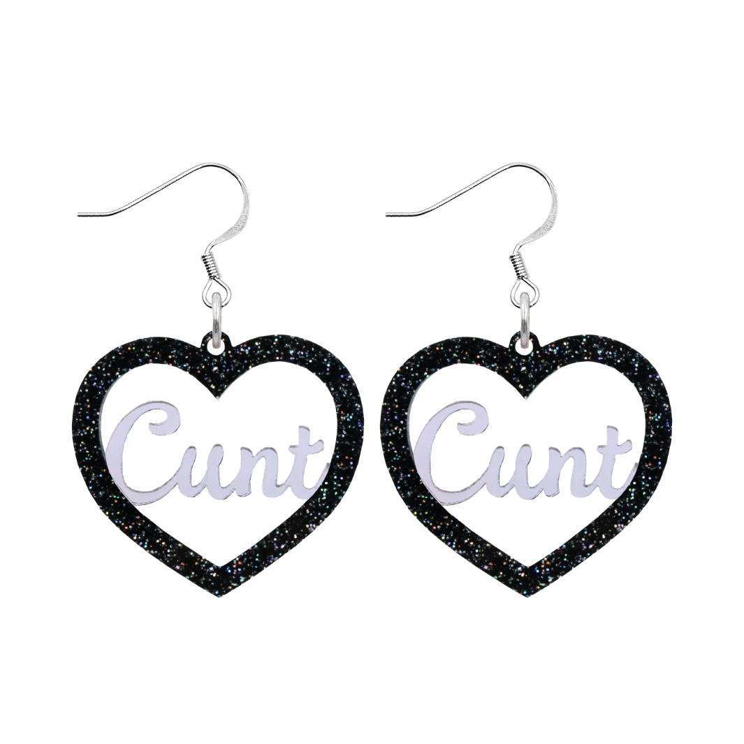 An image of Haus of Dizzy's Small ‘Cunt' heart shaped dangle earrings, with mirror "Cunt" text on a Black Glitter acrylic on a hook.