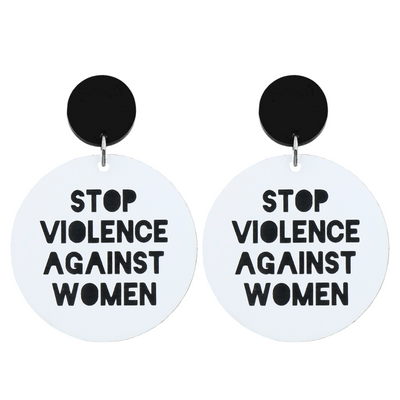 A picture of Large white acrylic dangle earrings with a black stud top that say "stop violence against women" in black text