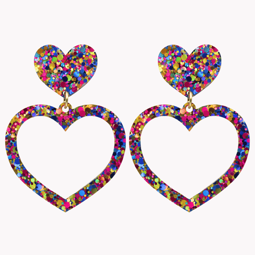 haus of dizzy confetti barbie heart earrings with purple, magenta, and gold glitter through a clear base size large