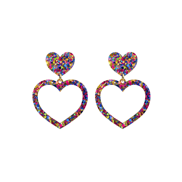 haus of dizzy confetti barbie heart earrings with purple, magenta, and gold glitter through a clear base size small