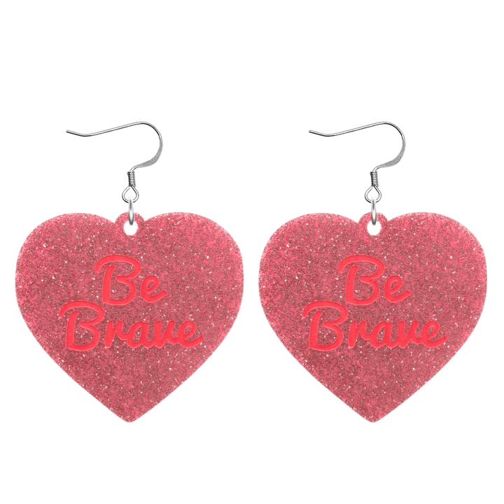 haus of dizzy baby pink glitter heart-shaped acrylic earrings with bright red 'Be Brave' text and silver hooks no heart tops size large