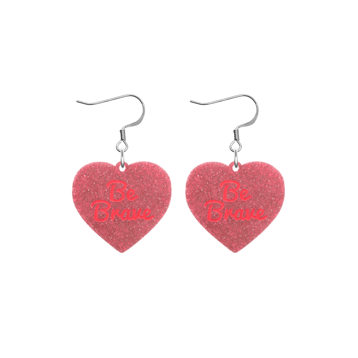 haus of dizzy baby pink glitter heart-shaped acrylic earrings with bright red 'Be Brave' text and silver hooks no heart tops size small