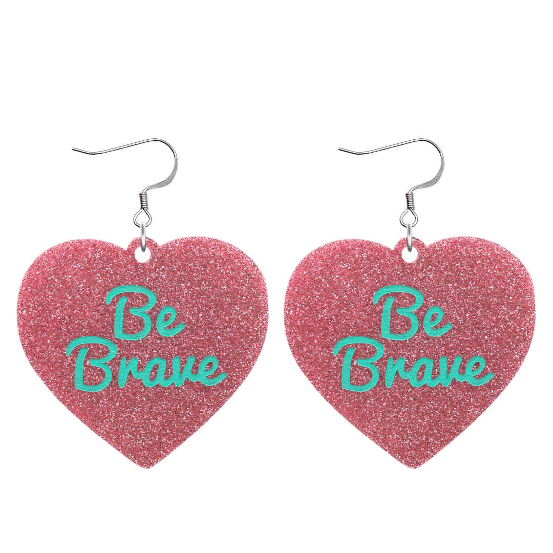 haus of dizzy baby pink glitter heart-shaped acrylic earrings with turquoise 'Be Brave' text and silver hooks no heart tops size large