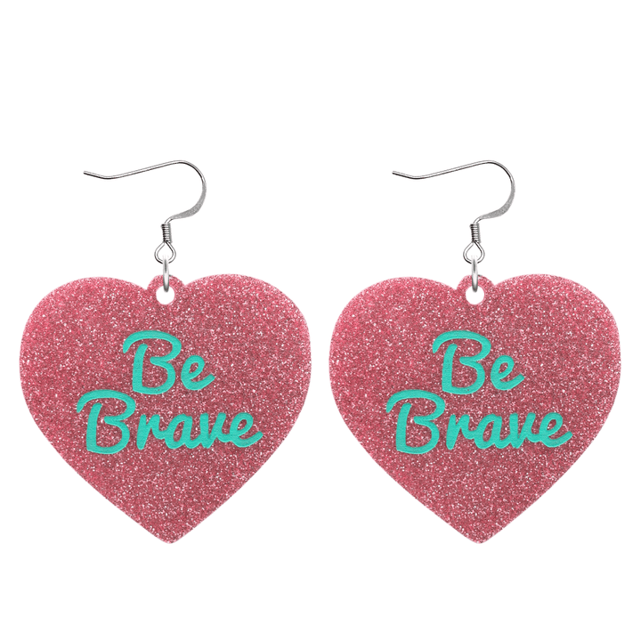 haus of dizzy baby pink glitter heart-shaped acrylic earrings with turquoise 'Be Brave' text and silver hooks no heart tops size large