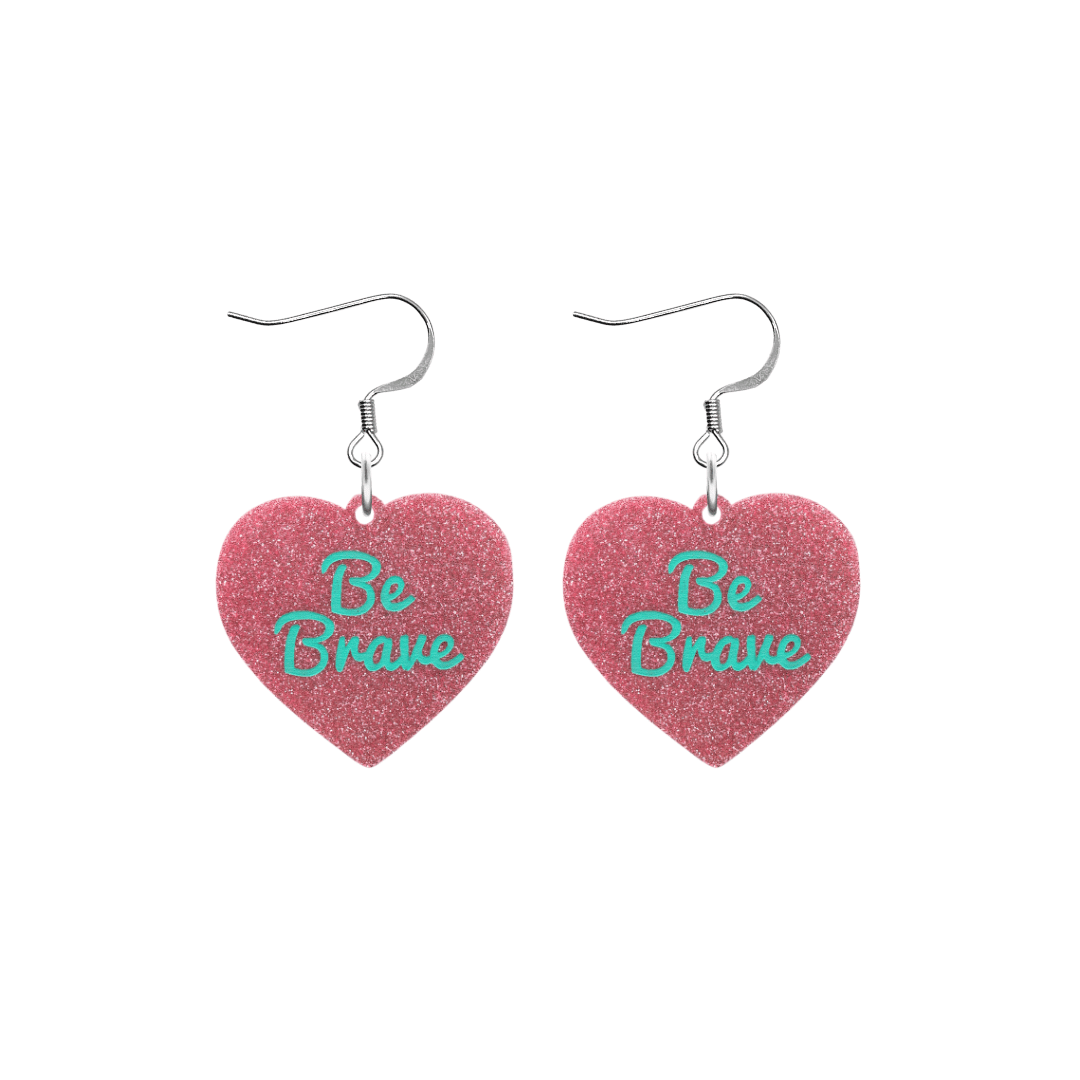 haus of dizzy baby pink glitter heart-shaped acrylic earrings with turquoise 'Be Brave' text and silver hooks no heart tops size small