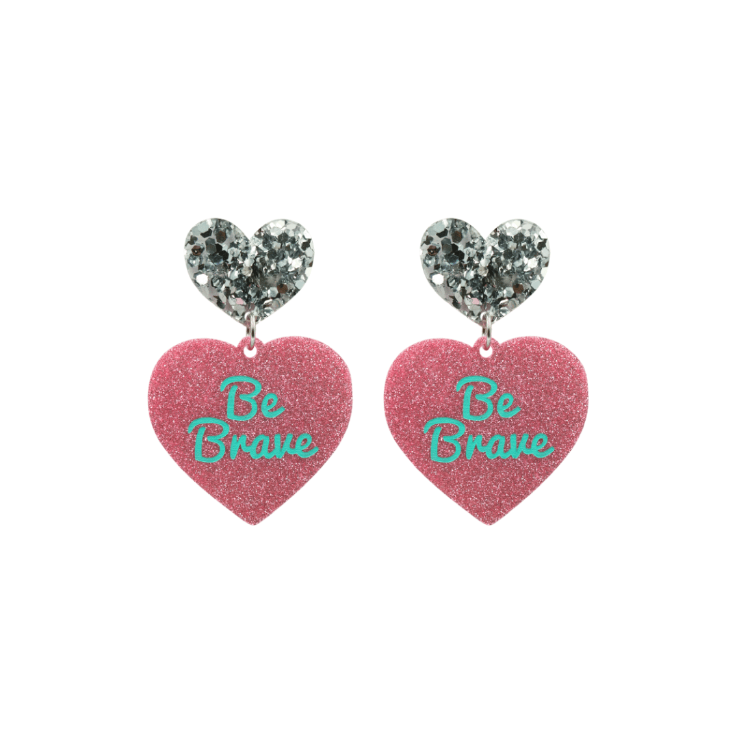 haus of dizzy baby pink glitter heart-shaped acrylic earrings with turquoise 'Be Brave' text and chunky silver glitter heart tops size small