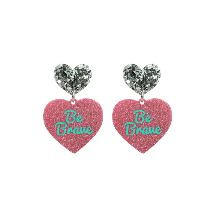 haus of dizzy baby pink glitter heart-shaped acrylic earrings with turquoise 'Be Brave' text and chunky silver glitter heart tops size small