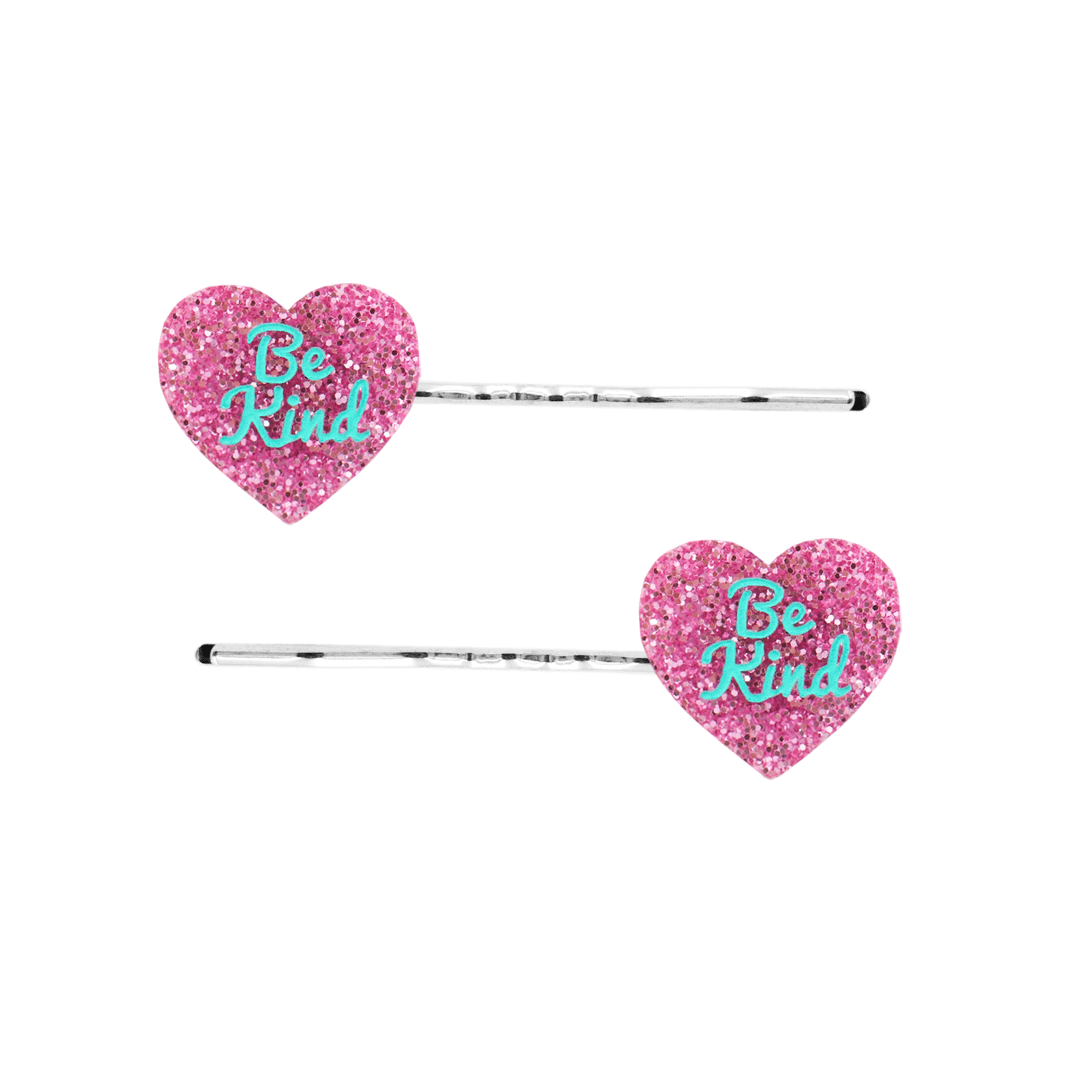 haus of dizzy two pink glitter heart-shaped acrylic pieces with aqua 'Be Kind' text on silver bobby hair pins