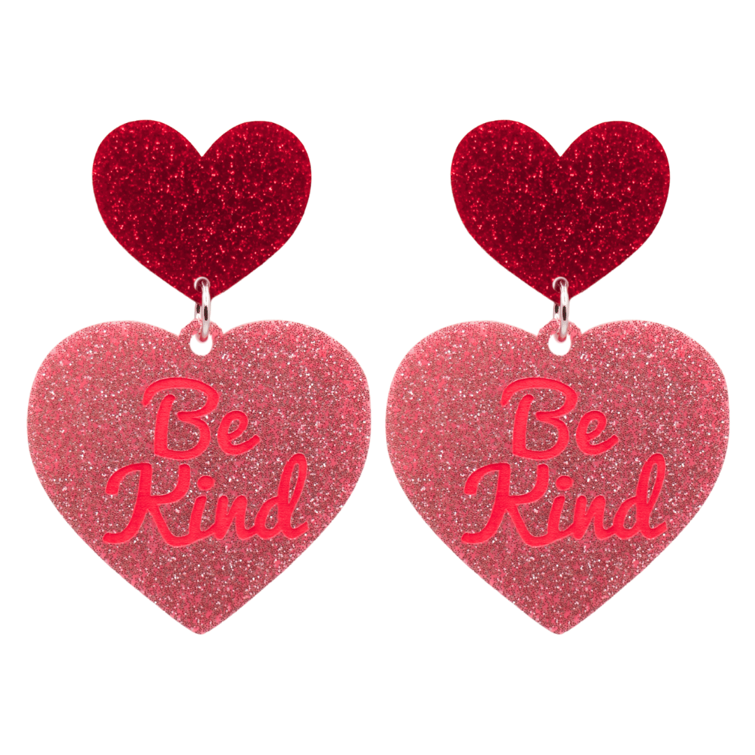 haus of dizzy baby pink glitter heart-shaped acrylic earrings with bright red 'Be Kind' text and red glitter heart tops size large