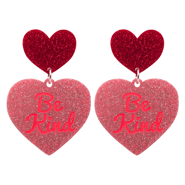 haus of dizzy baby pink glitter heart-shaped acrylic earrings with bright red 'Be Kind' text and red glitter heart tops size large