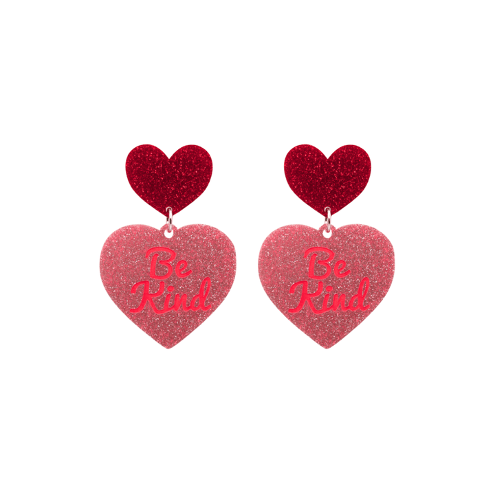 haus of dizzy baby pink glitter heart-shaped acrylic earrings with bright red 'Be Kind' text and red glitter heart tops size small