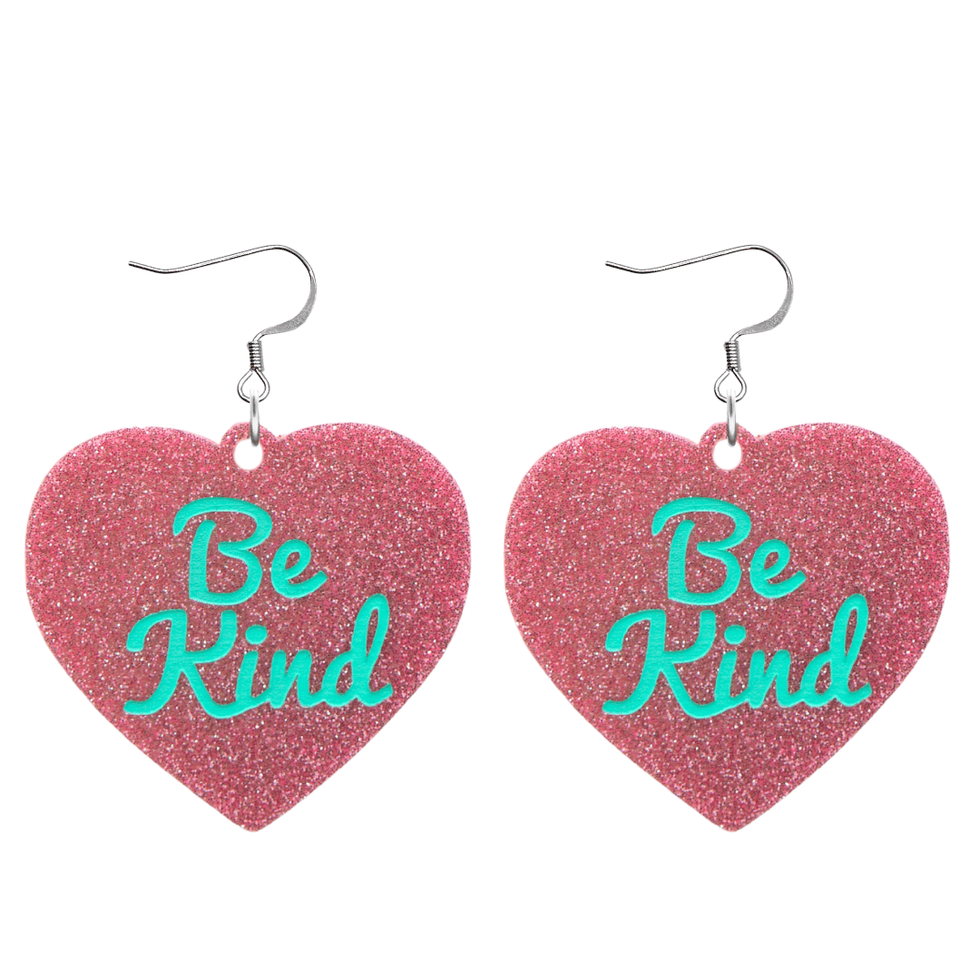 haus of dizzy baby pink glitter heart-shaped acrylic earrings with turquoise 'Be Kind' text and silver hooks no heart tops size large