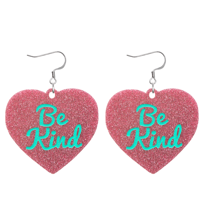 haus of dizzy baby pink glitter heart-shaped acrylic earrings with turquoise 'Be Kind' text and silver hooks no heart tops size large