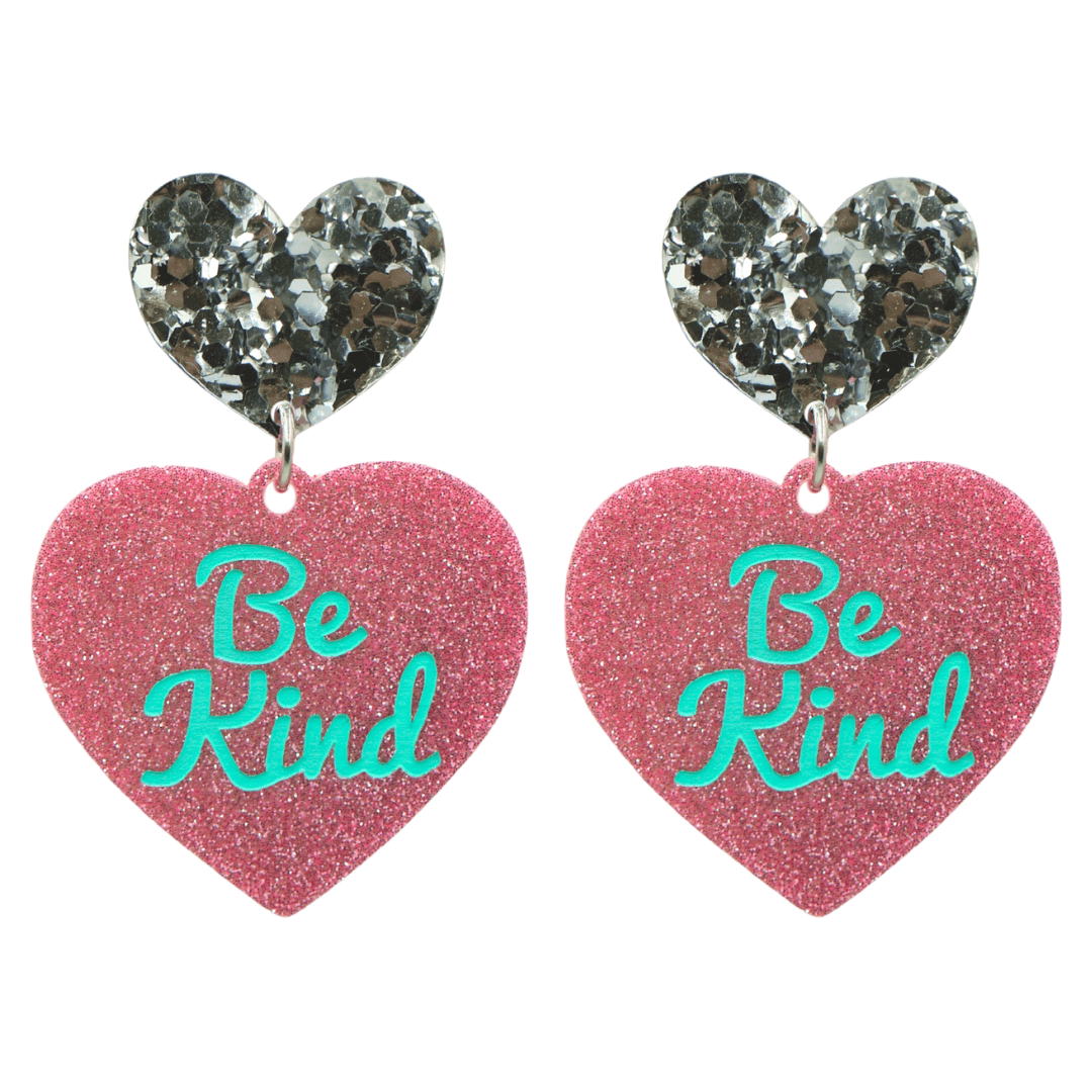 haus of dizzy baby pink glitter heart-shaped acrylic earrings with turquoise 'Be Kind' text and chunky silver glitter heart tops size large
