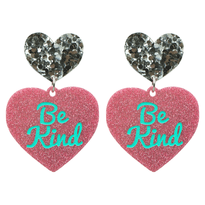 haus of dizzy baby pink glitter heart-shaped acrylic earrings with turquoise 'Be Kind' text and chunky silver glitter heart tops size large