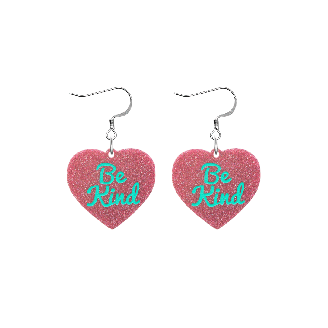 haus of dizzy baby pink glitter heart-shaped acrylic earrings with turquoise 'Be Kind' text and silver hooks no heart tops size small
