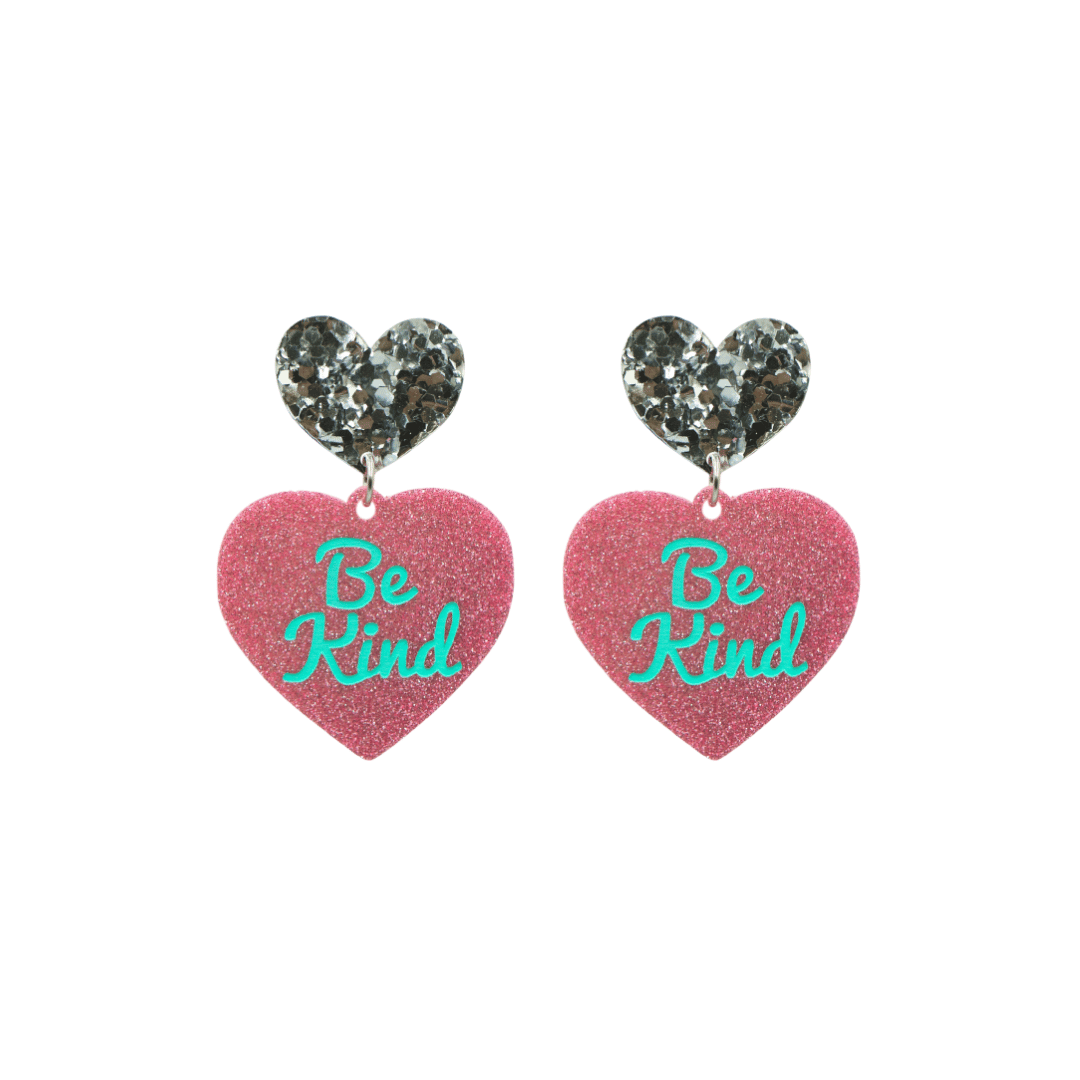 haus of dizzy baby pink glitter heart-shaped acrylic earrings with turquoise 'Be Kind' text and chunky silver glitter heart tops size small
