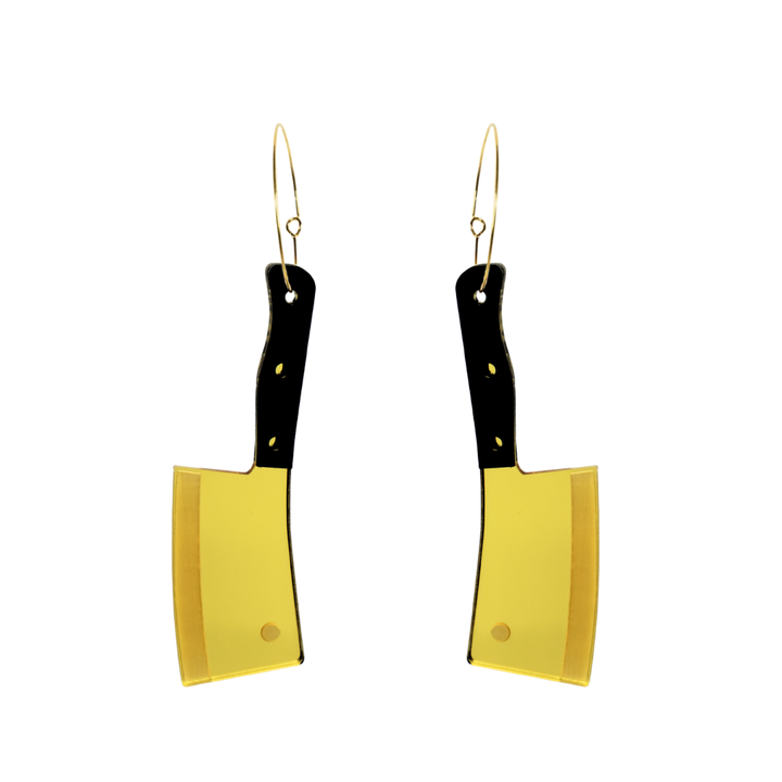 Haus of dizzy cleaver shaped earrings with black handles and gold blades on a white background