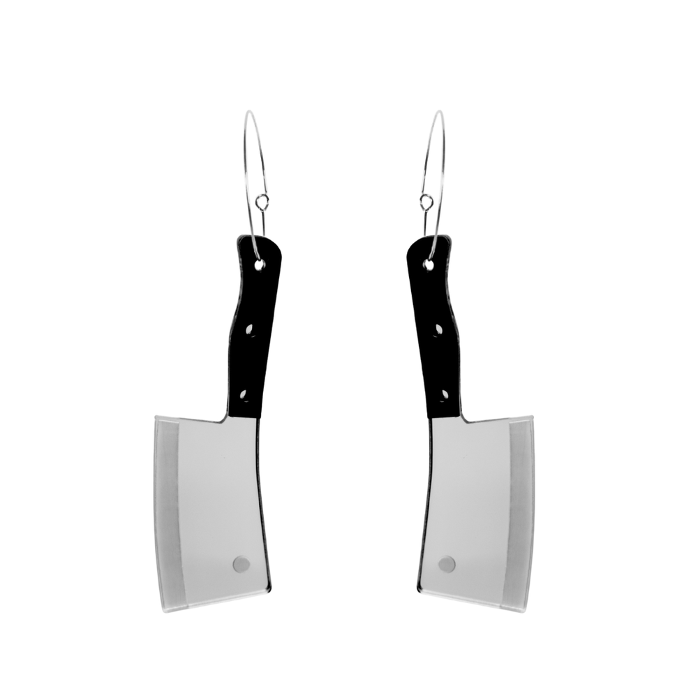 Haus of dizzy cleaver shaped earrings with black handles and silver blades on a white background