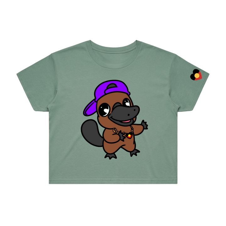 sage green crop t-shirt with a cartoon platypus, Bunji, wearing a purple hat and Aboriginal flag chain, t-shirt is on a white background