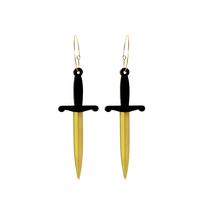 Haus of dizzy dagger sword shaped earrings with black handles and gold blades on a white background