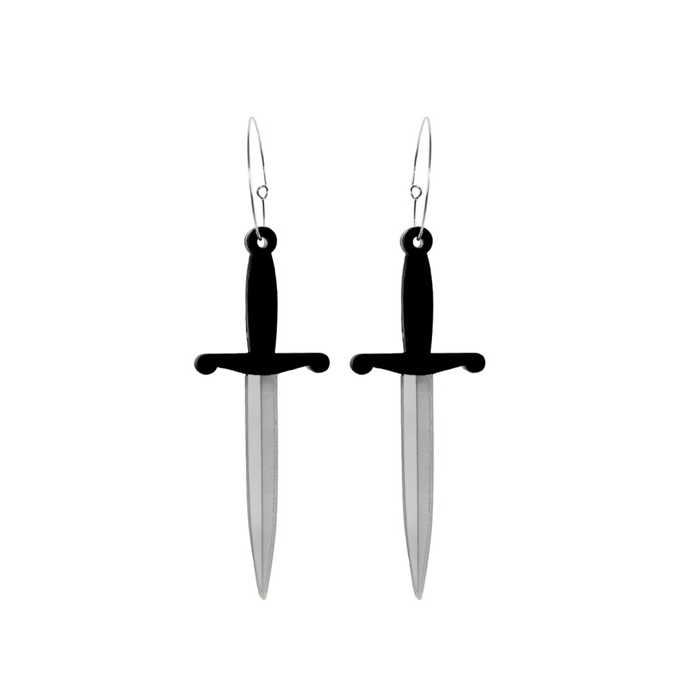 Haus of dizzy dagger sword shaped earrings with black handles and silver blades on a white background