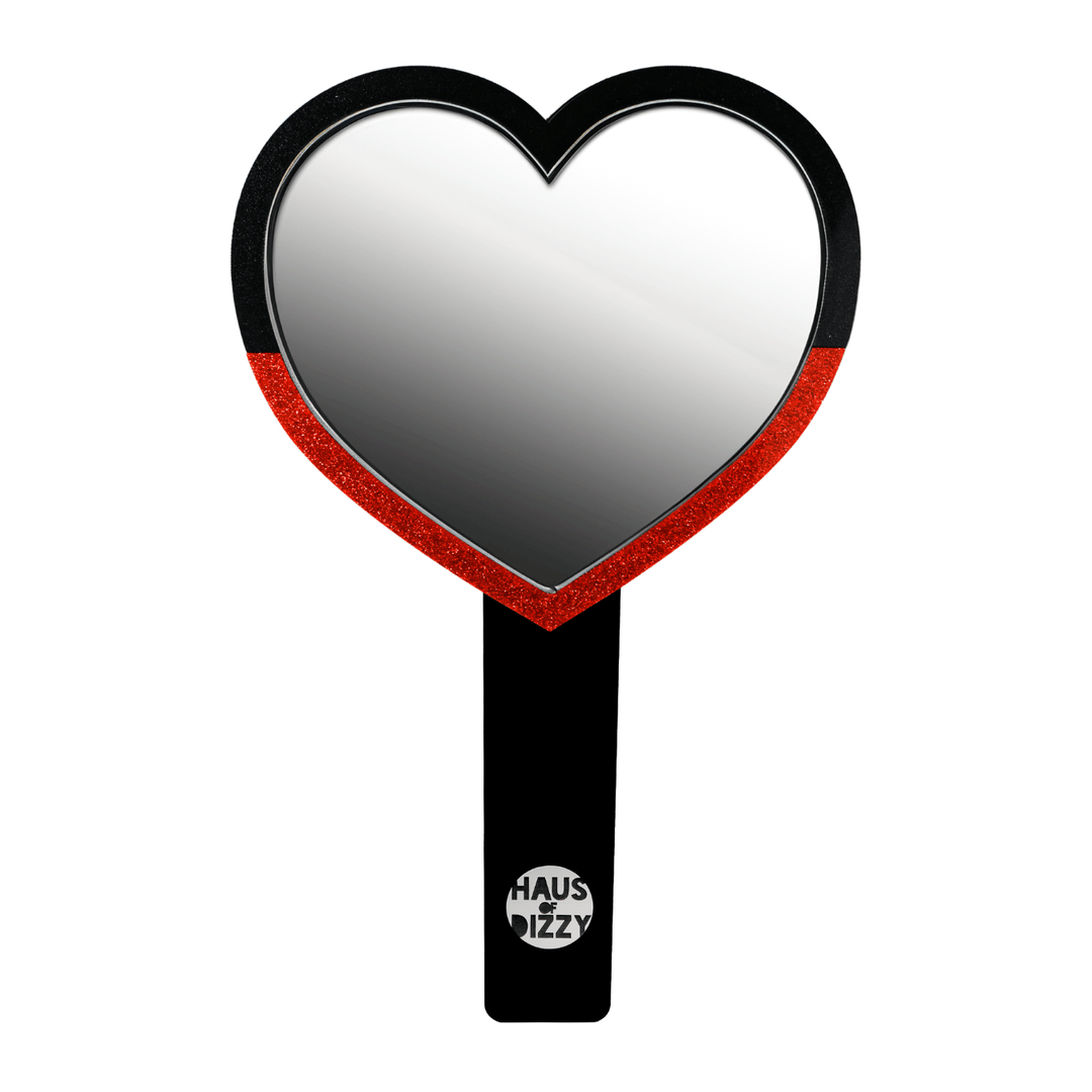 haus of dizzy heart-shaped handheld mirror, with a black handle with haus of dizzy silver logo at bottom of handle. front view, size large