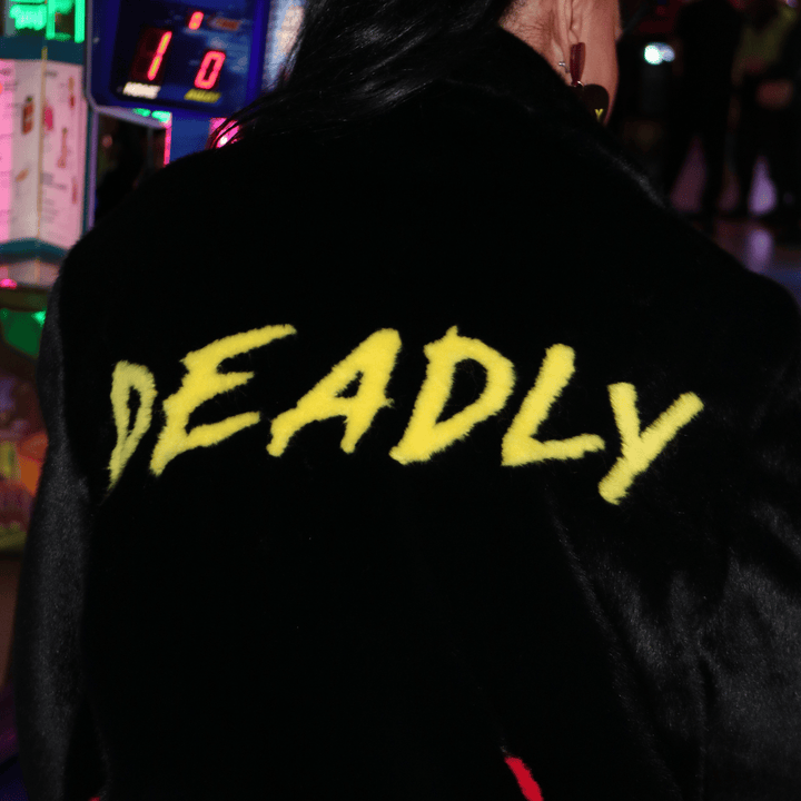 close up image of the word deadly on the haus of dizzy x tibbs and bones 'deadly flamez' fur jacket