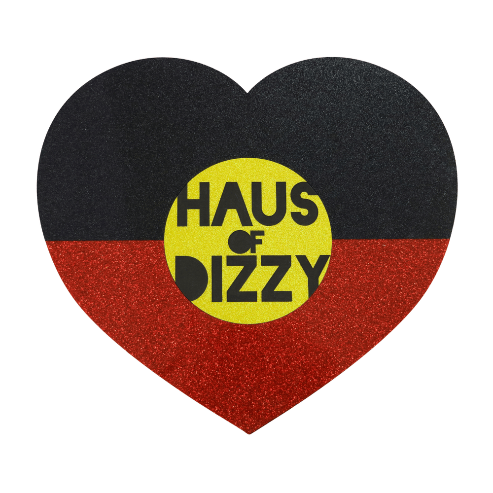 hand made heart-shaped acrylic jewellery box in Aboriginal flag colours. using black, yellow, and red glitter acrylic with hand painted haus of dizzy logo in yellow sun centre birds eye view