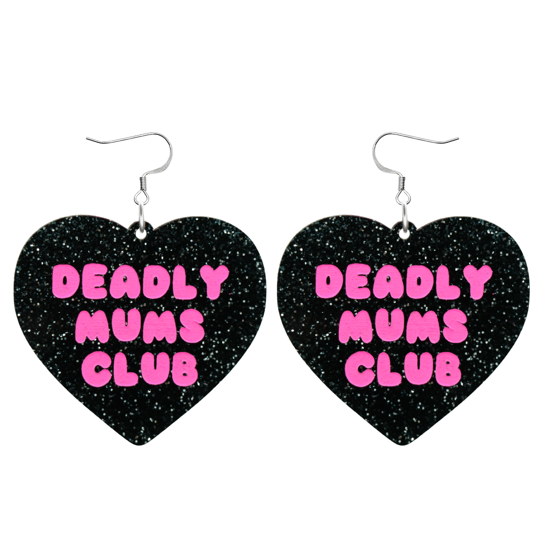 haus of dizzy earrings with a black glittery acrylic heart shape body with the phrase 'deadly mums club' hand painted in hot pink with hooks no heart tops size large
