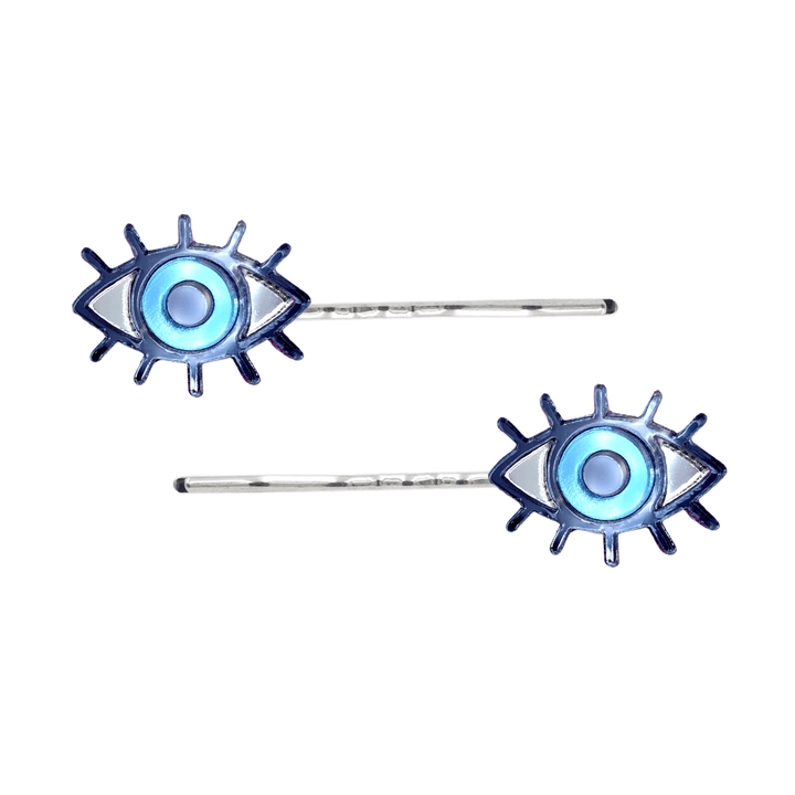 haus of dizzy eye see you hair pins set of two. Eye-shaped hair pins with blue mirror centers and silver hairpins on a white background