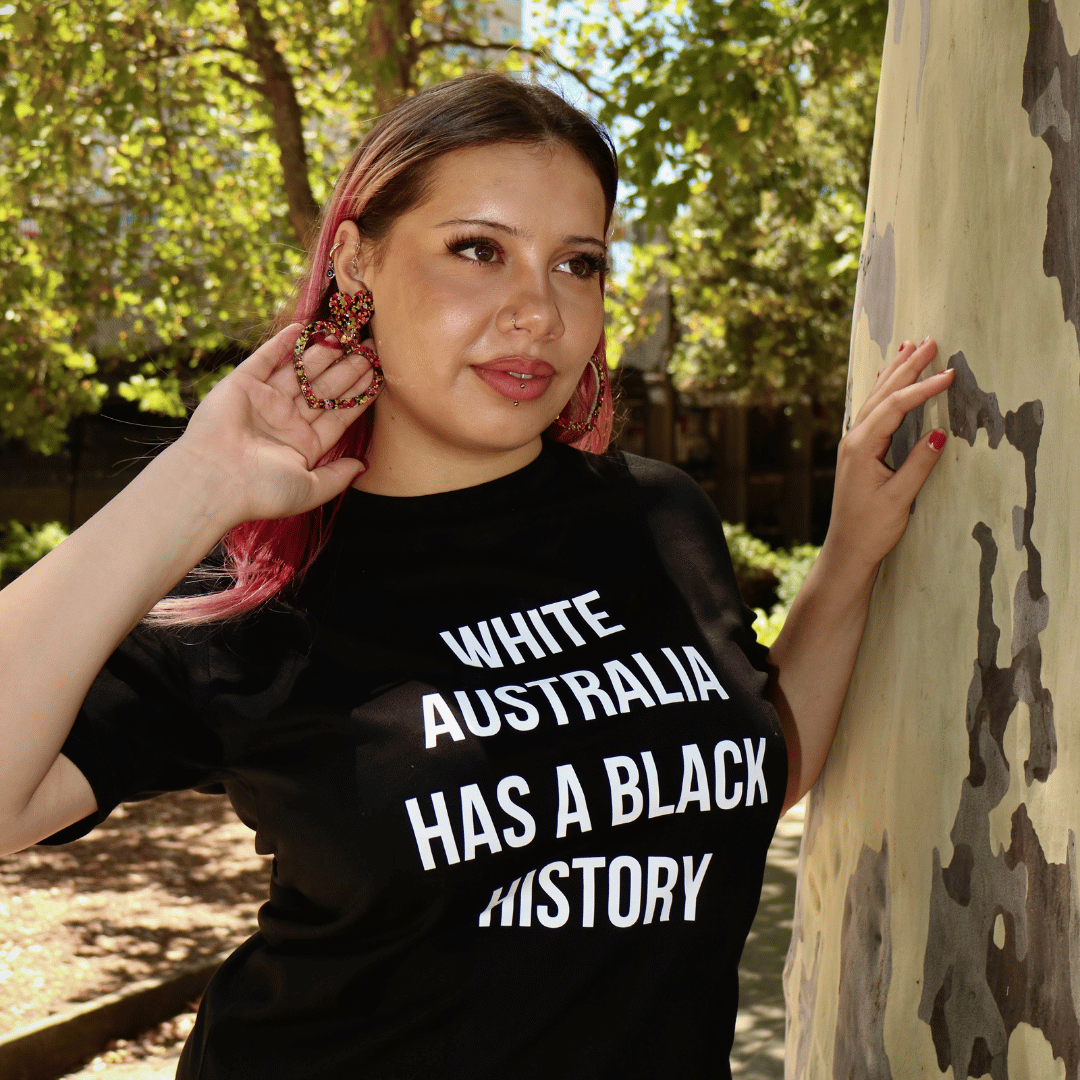 image of model wearing haus of dizzy giiny heart hoop earrings in nature next to a tree. giiny means heart in wiradjuri language.