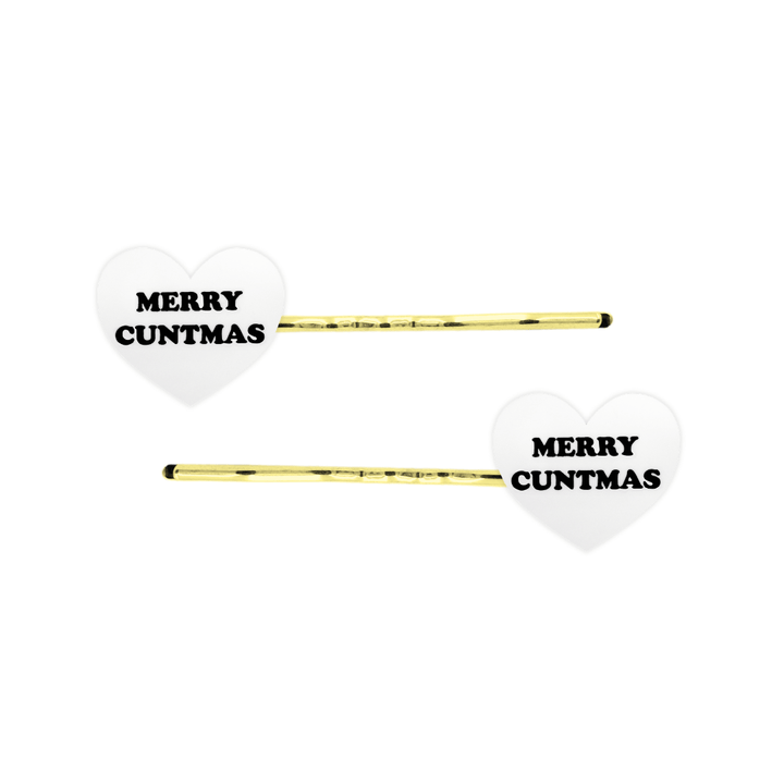 haus of dizzy white heart-shaped acrylic hearts on gold hair pins with black 'MERRY CUNTMAS' text on a white background