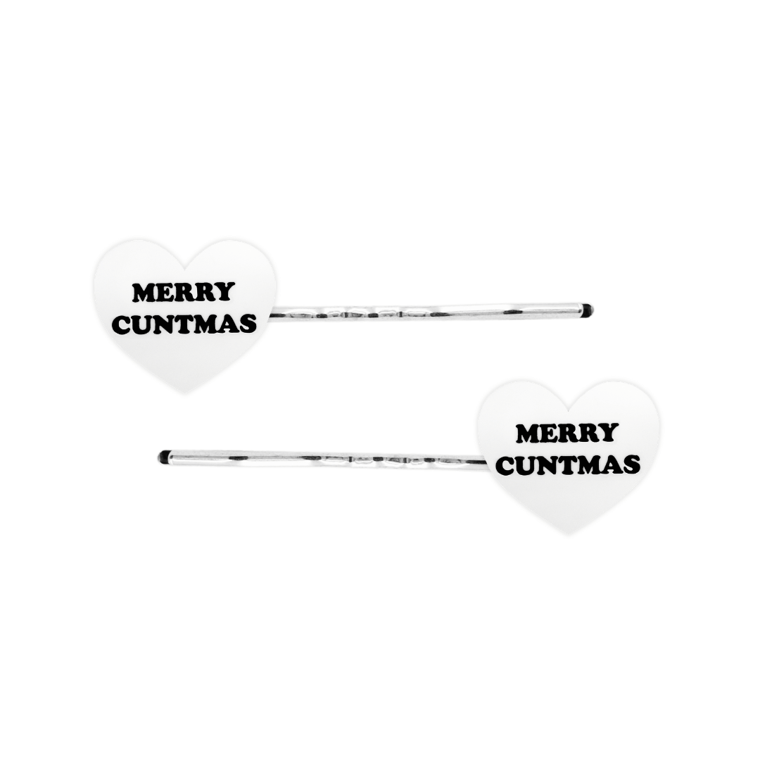 haus of dizzy white heart-shaped acrylic hearts on silver hair pins with black 'MERRY CUNTMAS' text on a white background