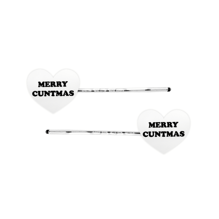 haus of dizzy white heart-shaped acrylic hearts on silver hair pins with black 'MERRY CUNTMAS' text on a white background