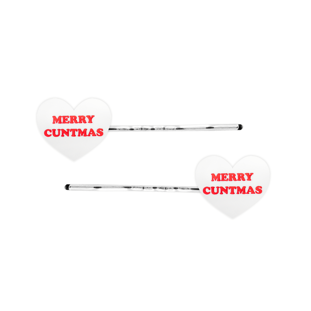 haus of dizzy white heart-shaped acrylic hearts on silver hair pins with red 'MERRY CUNTMAS' text on a white background