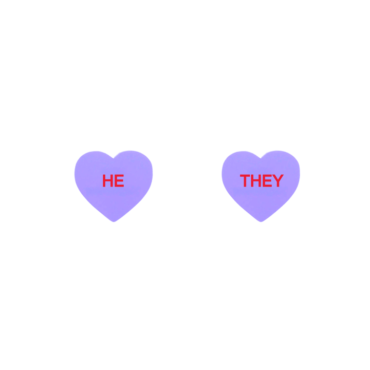 haus of dizzy pastel grape candy heart studs with pronouns HE and THEY in hand painted red text one word on each stud