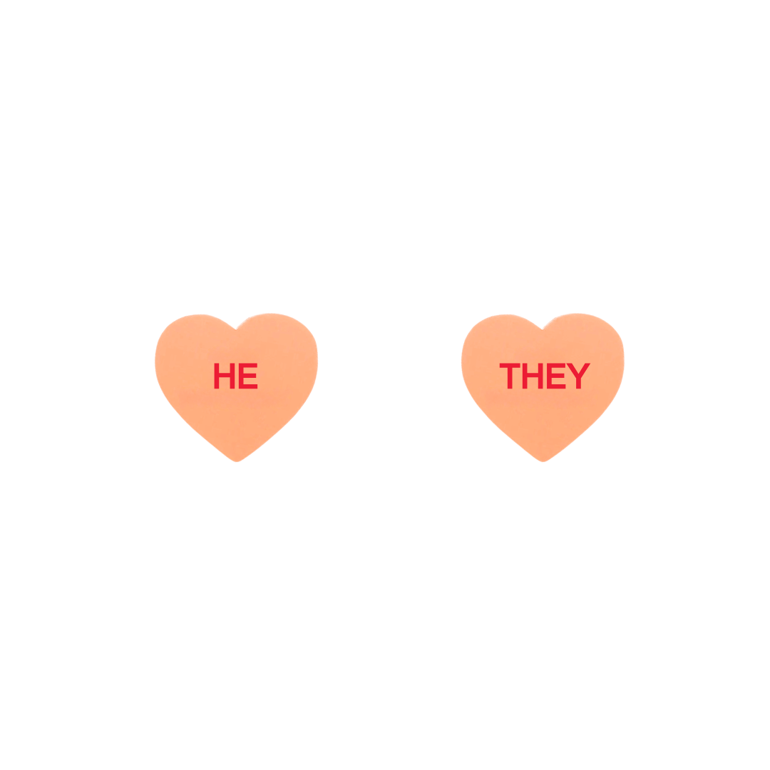 haus of dizzy pastel peach candy heart studs with pronouns HE and THEY in hand painted red text one word on each stud
