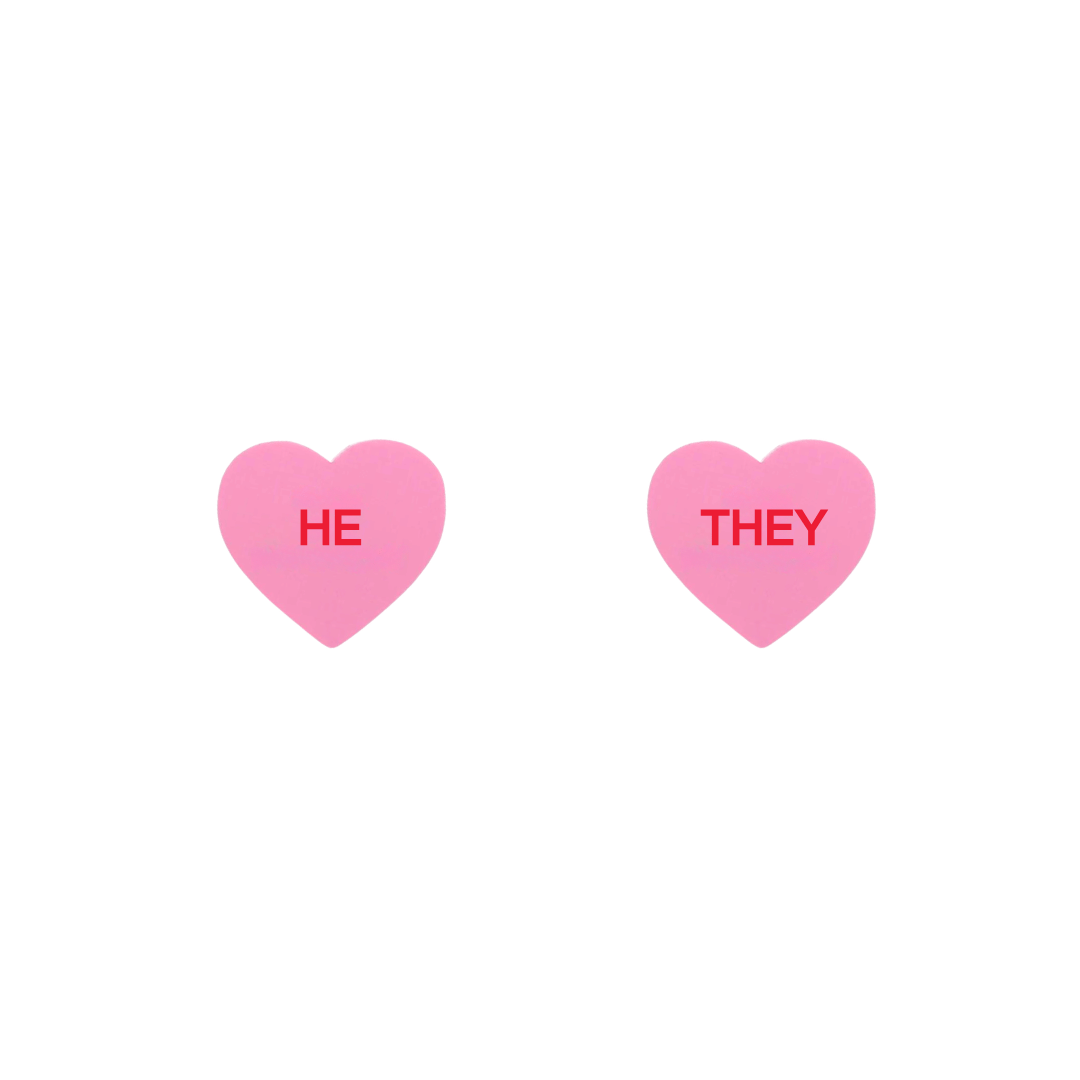 haus of dizzy pastel pink candy heart studs with pronouns HE and THEY in hand painted red text one word on each stud