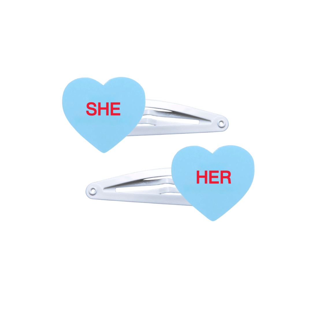 haus of dizzy two pastel blue candy heart acrylic pieces on white hair snap clips with pronouns SHE and HER hand painted red text one word on each hair clip
