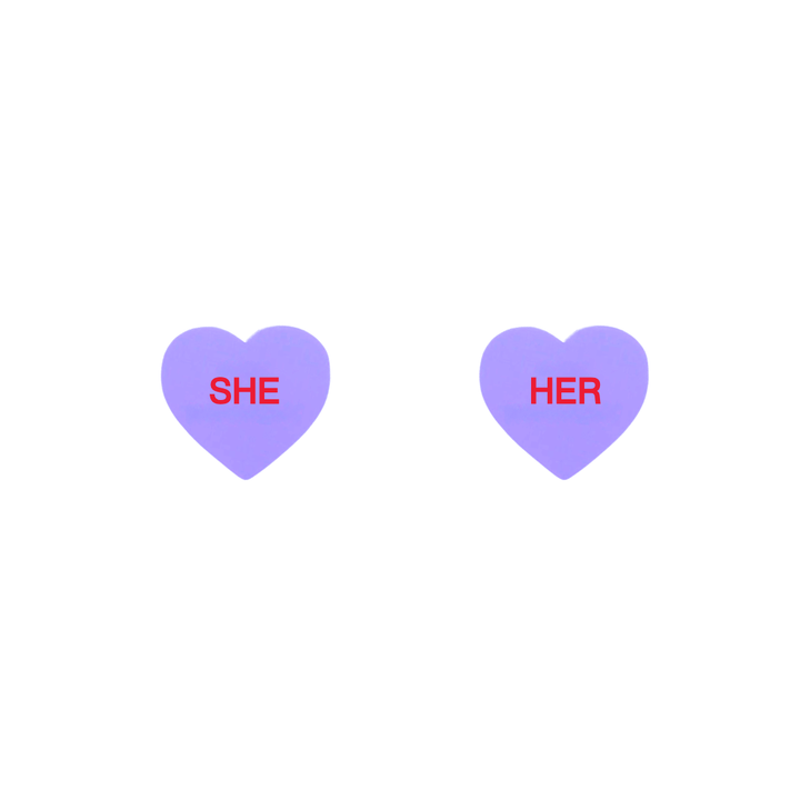 haus of dizzy pastel grape candy heart studs with pronouns SHE and HER in hand painted red text one word on each stud