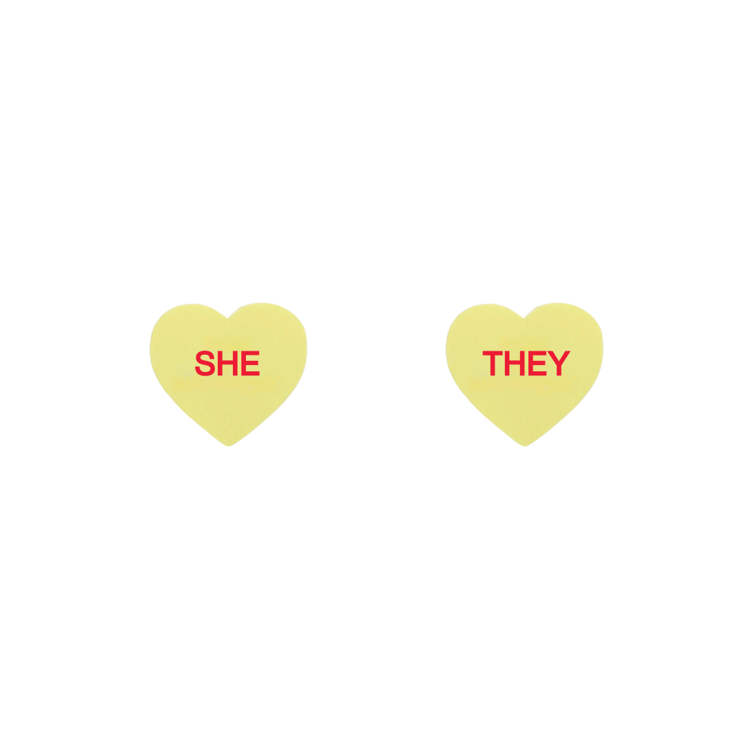 haus of dizzy pastel lemon candy heart studs with pronouns SHE and THEY in hand painted red text one word on each stud