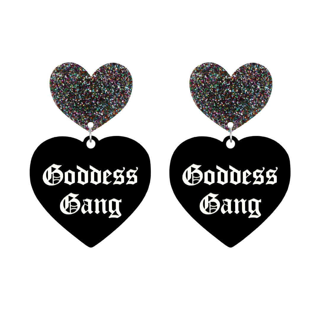 haus of dizzy black Heart-shaped earrings with 'Goddess Gang' text in white old english font with multi coloured glittery hearts tops size large