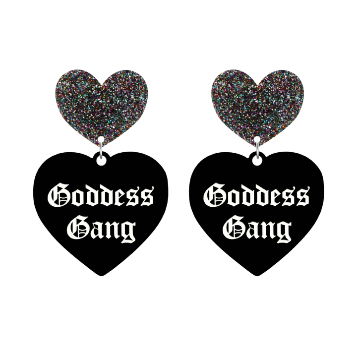 haus of dizzy black Heart-shaped earrings with 'Goddess Gang' text in white old english font with multi coloured glittery hearts tops size large