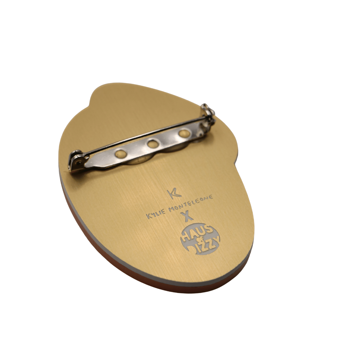 haus of dizzy x kylie monteleone collaboration ant nest badge back view featuring custom etched design of artists' logos