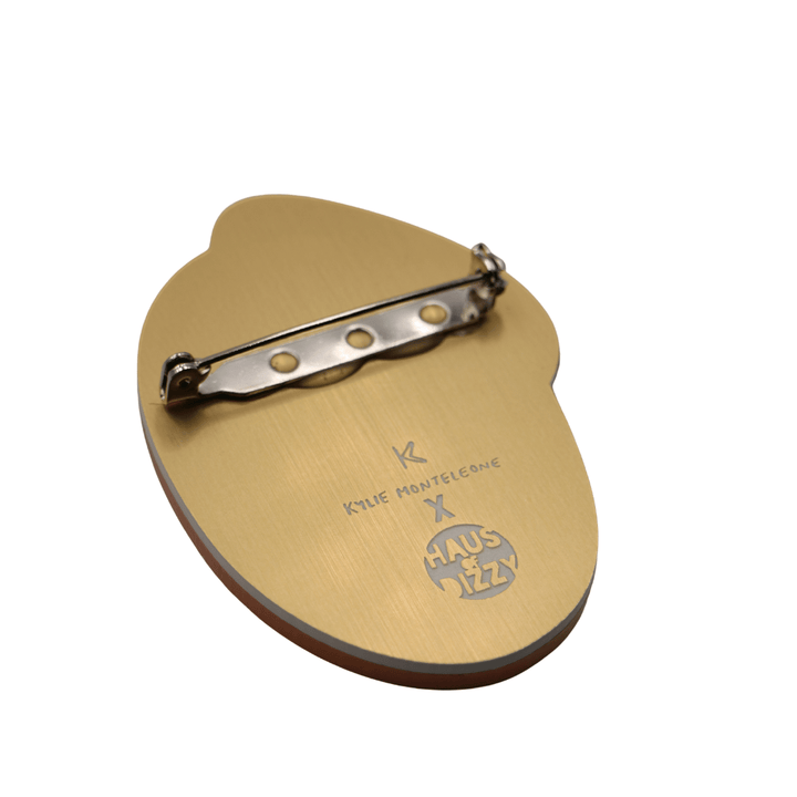 haus of dizzy x kylie monteleone collaboration ant nest badge back view featuring custom etched design of artists' logos